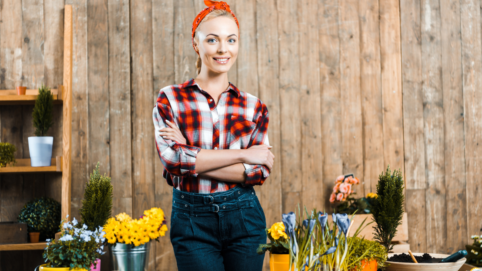 A young woman standing in front of a flower shop.